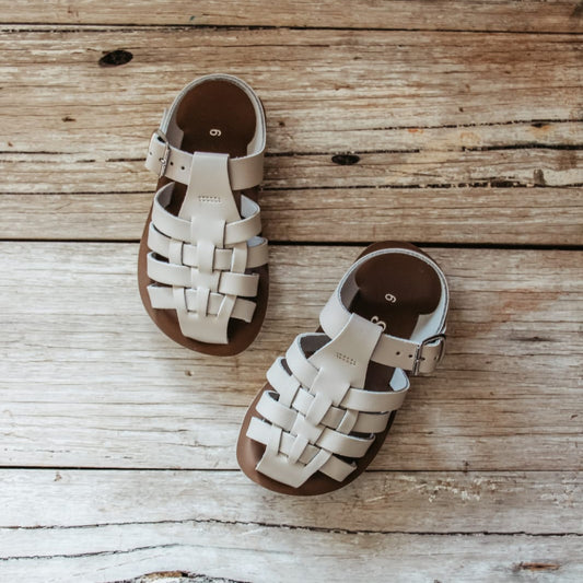Pair of woven sandals on a wooden surface
